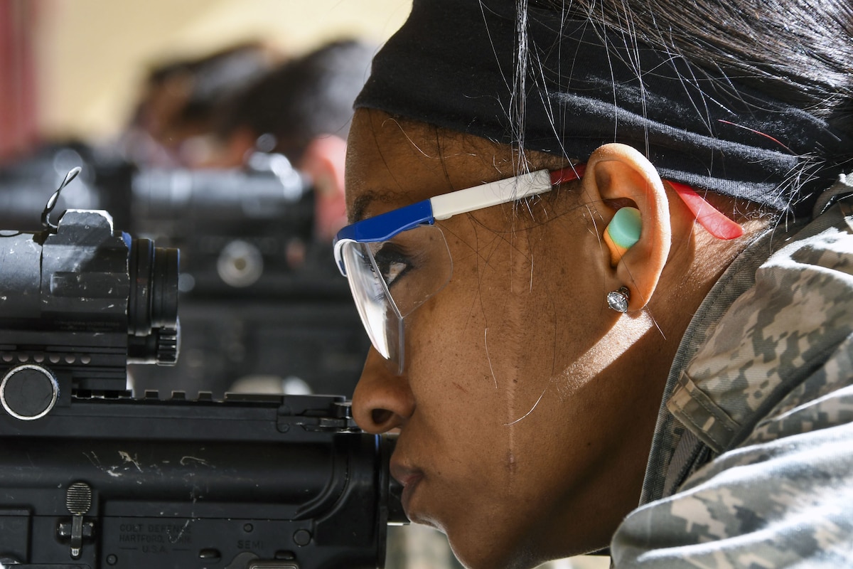 An airman aims at a target during weapons training.