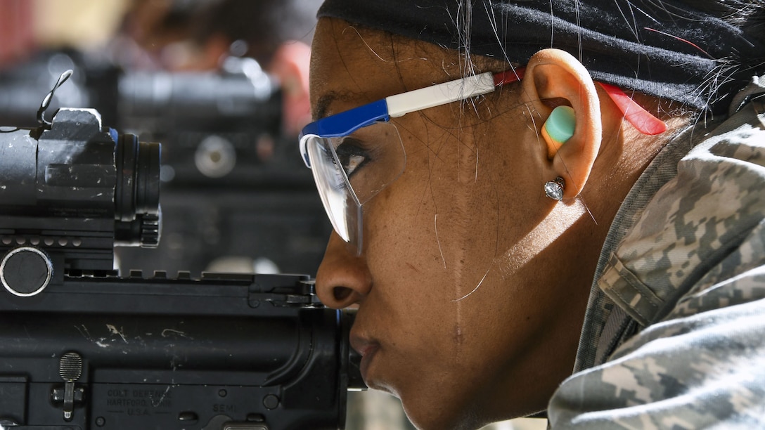 An airman aims at a target during weapons training.