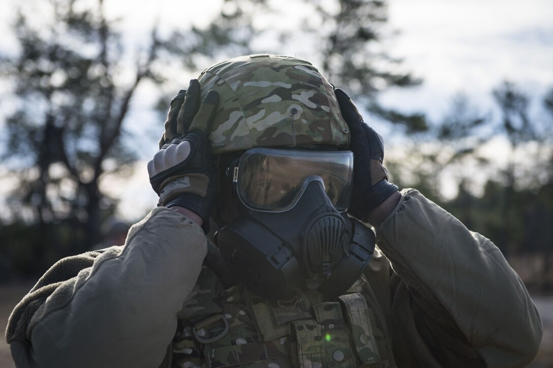 Airman 1st Class Ferriel Burns, 824th Base Defense Squadron fireteam member, adjusts his helmet and gas mask, Jan. 25, 2018, at Camp Blanding Joint Training Center, Fla.The Airmen traveled to Blanding to participate in Weapons Week where they qualified on heavy weapons ranging from the M249 light machine gun to the M18 Claymore mine. (U.S. Air Force photo by Senior Airman Janiqua P. Robinson)