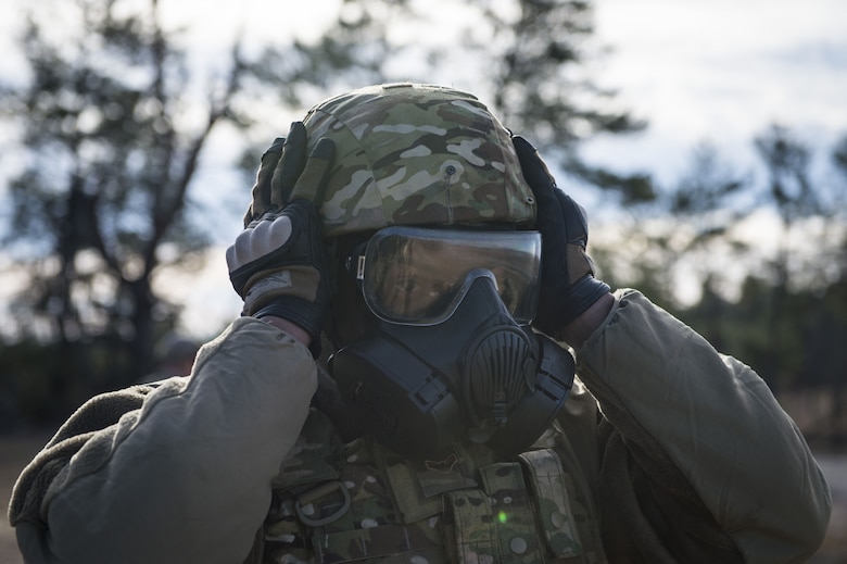 Airman 1st Class Ferriel Burns, 824th Base Defense Squadron fireteam member, adjusts his helmet and gas mask, Jan. 25, 2018, at Camp Blanding Joint Training Center, Fla.The Airmen traveled to Blanding to participate in Weapons Week where they qualified on heavy weapons ranging from the M249 light machine gun to the M18 Claymore mine. (U.S. Air Force photo by Senior Airman Janiqua P. Robinson)