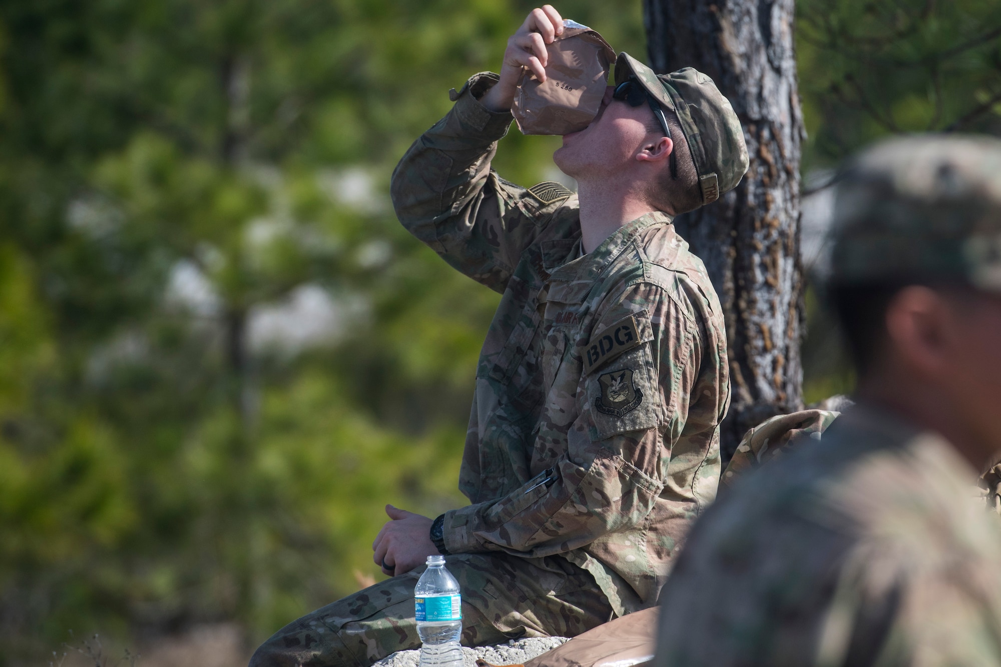 An Airman from the 824th Base Defense Squadron eats a snack during a break in training, Jan. 26, 2018, at Camp Blanding Joint Training Center, Fla. The Airmen traveled to Blanding to participate in Weapons Week where they qualified on heavy weapons ranging from the M249 light machine gun to the M18 Claymore mine. (U.S. Air Force photo by Senior Airman Janiqua P. Robinson)