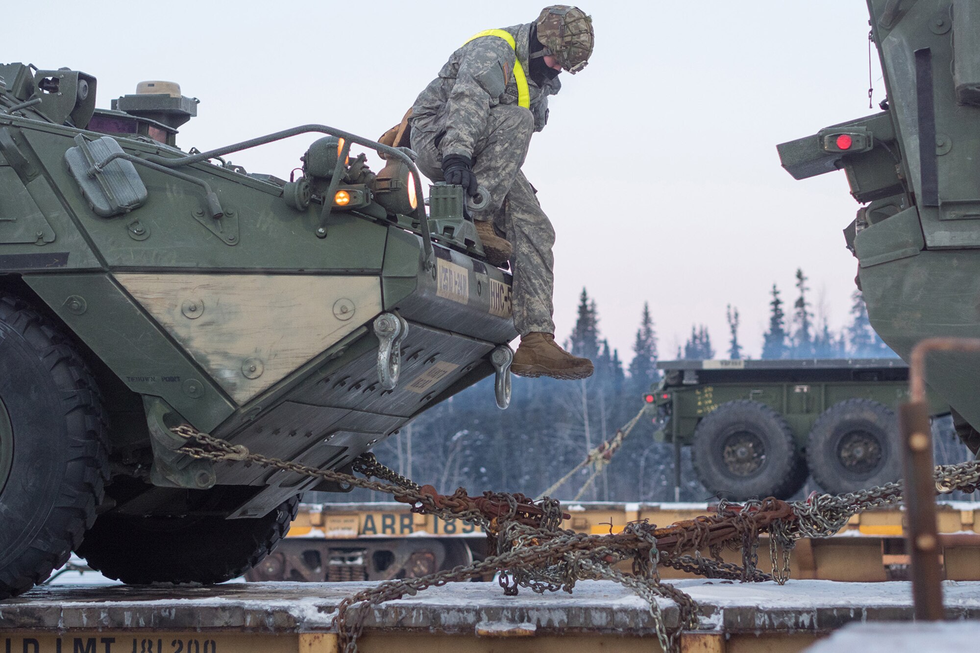 Soldiers assigned to the 1st Stryker Brigade Combat Team, 25th Infantry Division, U.S. Army Alaska, perform railhead operations in sub-zero temperatures on Joint Base Elmendorf-Richardson, Alaska, Jan. 30, 2018.  The Fort Wainwright-based Soldiers are off-loading their vehicles and equipment as part of Arctic Thrust, a short-notice rapid deployment exercise.