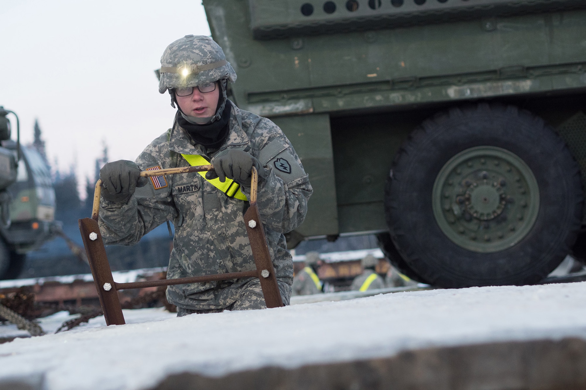 Soldiers assigned to the 1st Stryker Brigade Combat Team, 25th Infantry Division, U.S. Army Alaska, perform railhead operations in sub-zero temperatures on Joint Base Elmendorf-Richardson, Alaska, Jan. 30, 2018.  The Fort Wainwright-based Soldiers are off-loading their vehicles and equipment as part of Arctic Thrust, a short-notice rapid deployment exercise.