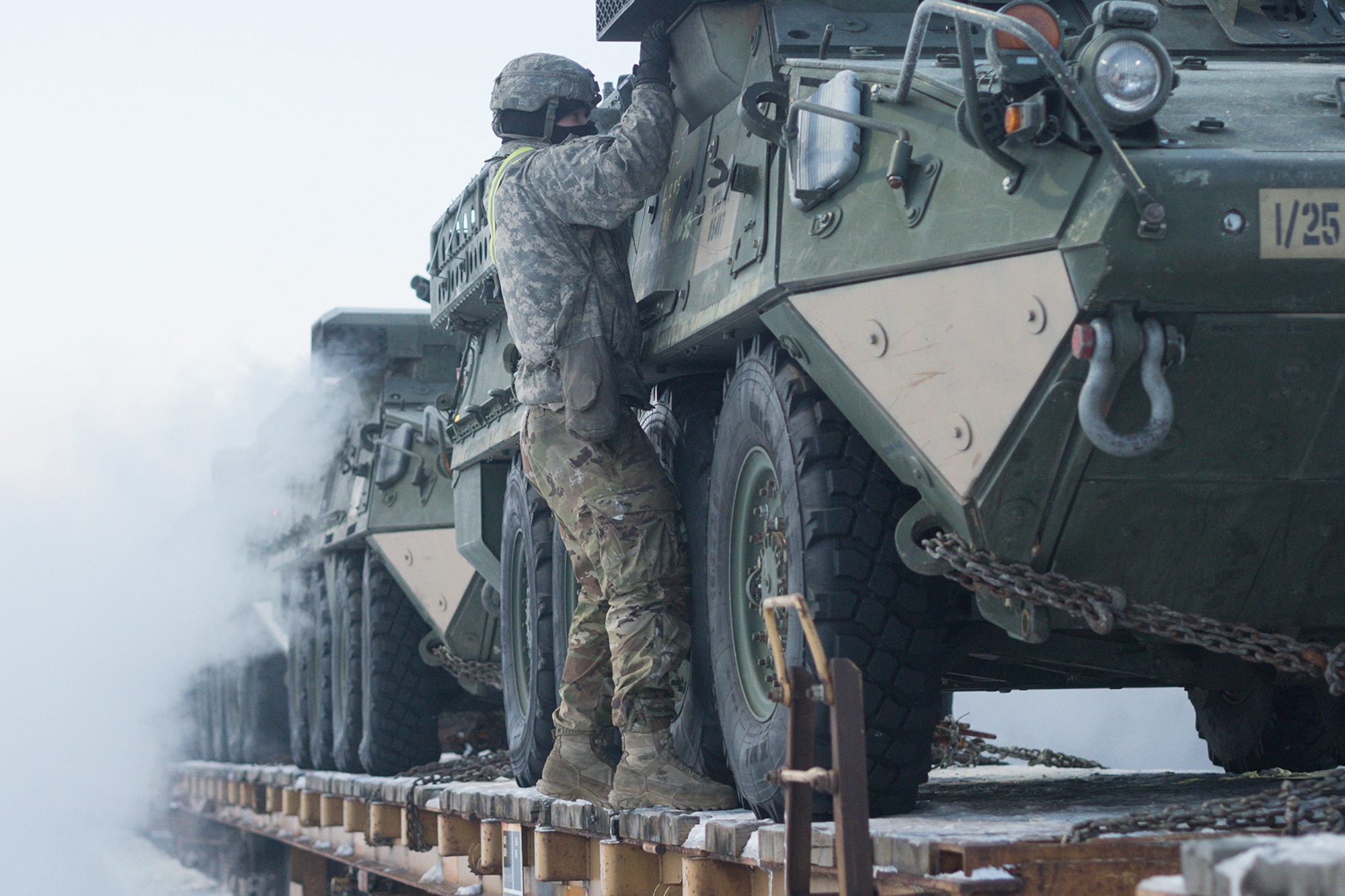 Soldiers assigned to the 1st Stryker Brigade Combat Team, 25th Infantry Division, U.S. Army Alaska, perform railhead operations in sub-zero temperatures on Joint Base Elmendorf-Richardson, Alaska, Jan. 30, 2018.  The Fort Wainwright-based Soldiers are off-loading their vehicles and equipment as part of Arctic Thrust, a short-notice rapid deployment exercise.