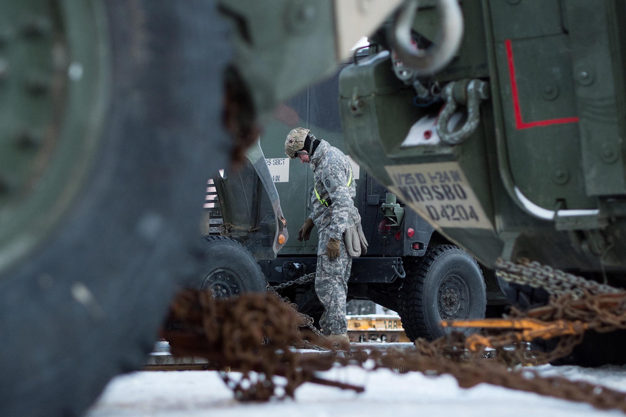 Soldiers assigned to the 1st Stryker Brigade Combat Team, 25th Infantry Division, U.S. Army Alaska, perform railhead operations in sub-zero temperatures on Joint Base Elmendorf-Richardson, Alaska, Jan. 30, 2018.  The Fort Wainwright-based Soldiers are off-loading their vehicles and equipment as part of Arctic Thrust, a short-notice rapid deployment exercise.