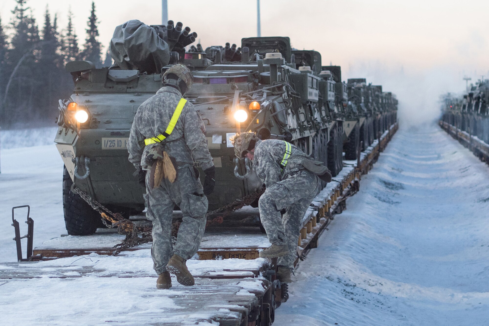 Soldiers assigned to the 1st Stryker Brigade Combat Team, 25th Infantry Division, U.S. Army Alaska, perform railhead operations in sub-zero temperatures on Joint Base Elmendorf-Richardson, Alaska, Jan. 30, 2018.  The Fort Wainwright-based Soldiers are off-loading their vehicles and equipment as part of Arctic Thrust, a short-notice rapid deployment exercise.