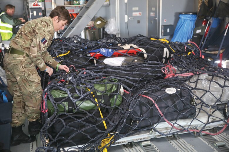 An Airman with the Royal Air Force secures a load of cargo on an A400 Atlas aboard Marine Corps Air Station Beaufort, Jan. 25.