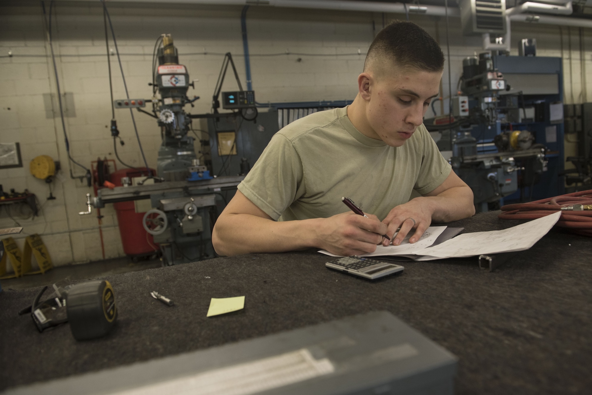 U.S. Air Force Airman 1st Class Walker James, 20th Equipment Maintenance Squadron metals technology technician, uses a blueprint to calculate measurements at Shaw Air Force Base, S.C., Jan. 30, 2018.