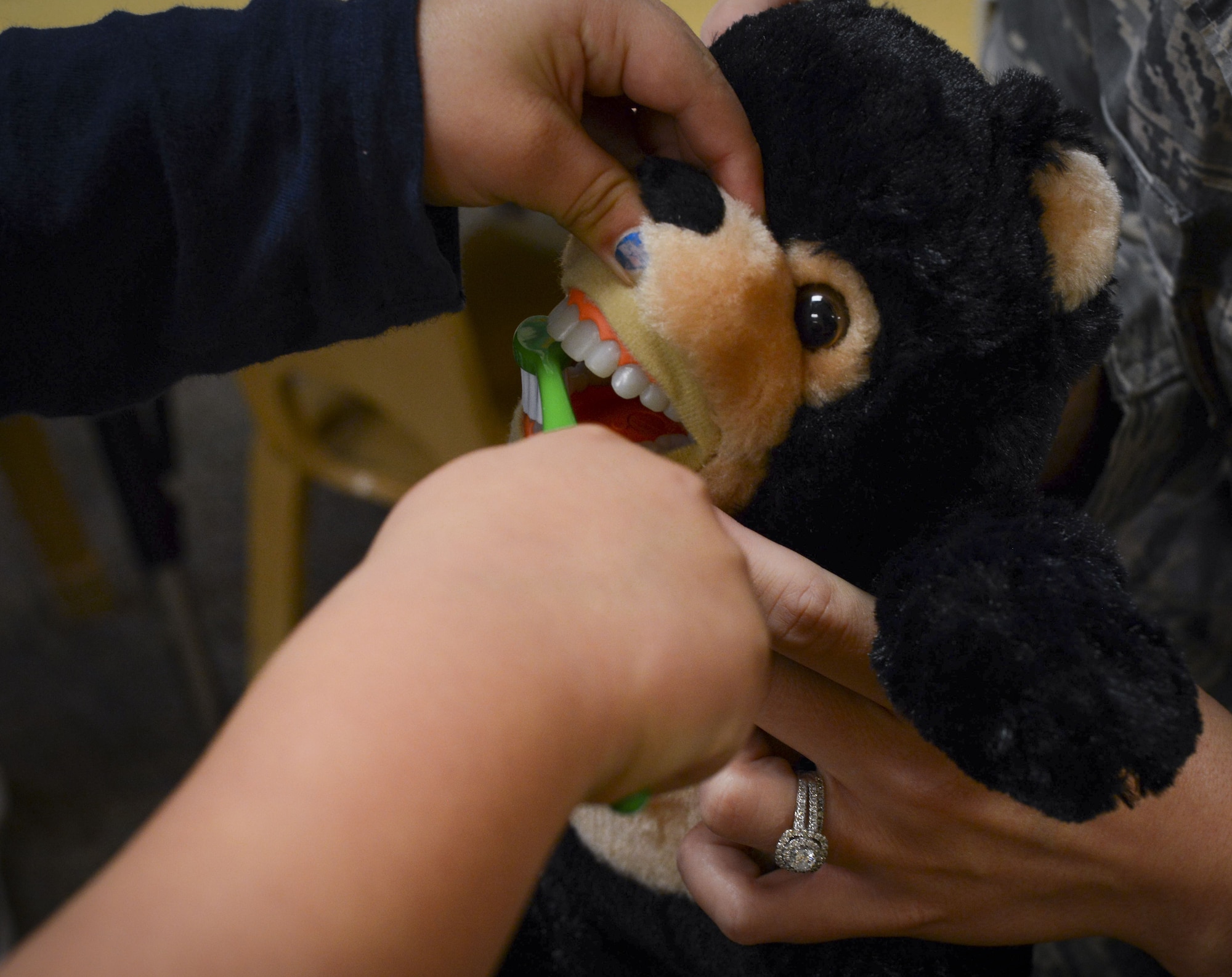 A child from Moody’s Child Development Center practices brushing teeth on a doll, Feb. 1, 2018, at Moody Air Force Base, Ga. Dental assistants from the 23d Aerospace Medicine Squadron visited the Child Development Center as part of National Children’s Dental Health Month, to teach children the importance of proper oral care and good habits for taking care of their teeth. (U.S. Air Force photo by Senior Airman Lauren M. Sprunk)
