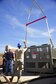 U.S. Air Force Senior Airman Henry Alexander 355th Civil Engineer Squadron heavy equipment operator, directs a crane operator during the positioning of new chiller at Davis-Monthan Air Force Base, Ariz., Jan. 30, 2018.