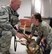 Staff Sgt. Craig Rainey, 78th Security Forces Military Working Dog Section, brings his MWD Macko in to the Robins Veterinary Treatment Facility, where Dr. (Capt) Adrienne Greenwood gives him a checkup. Active duty, National Guard, Reserve, retirees, 100 percent VA Medical and their family members may use the facility for their pets preventative care needs.