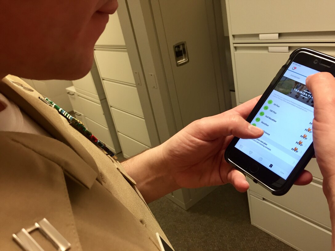 A service member looks at a fitness app on his smartphone at the Pentagon.