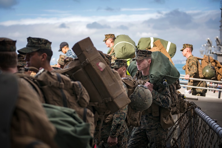 Marines, assigned to the 3d Marine Division (MARDIV), embark the amphibious assault ship USS Bonhomme Richard (LHD 6).