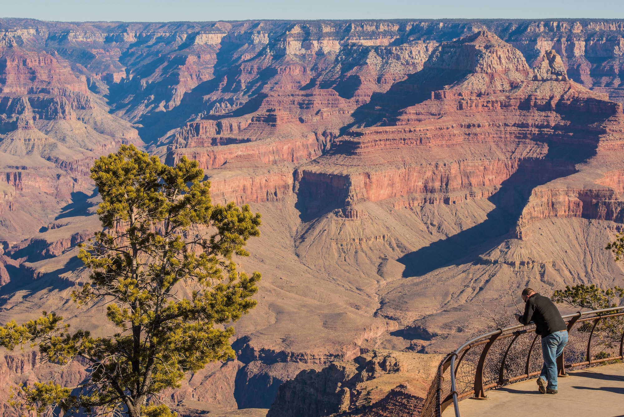 A visitor views the Grand Canyon from Mather Point in Grand Canyon National Park, Ariz., Jan. 27, 2018. For Airmen stationed at Luke Air Force Base, the Grand Canyon is one of the most popular destinations which they can visit while stationed in Arizona. (U.S. Air Force photo/Airman 1st Class Caleb Worpel)