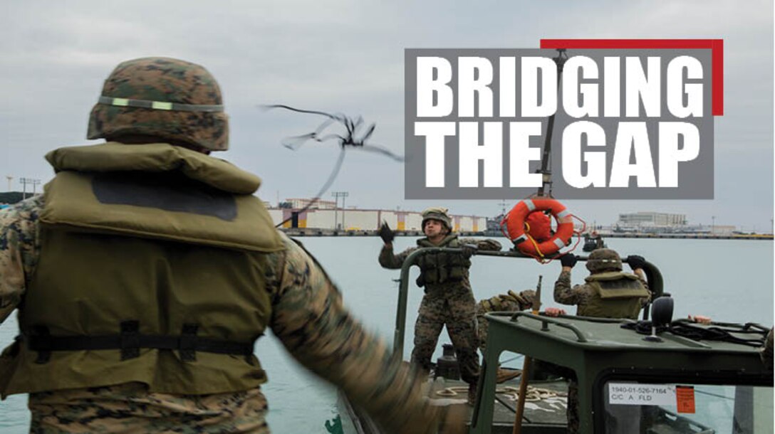 Lance Cpl. Andrew Hollom (left), a combat engineer with Bridge Company, 9th Engineer Support Battalion, Combat Logistics Regiment 35, throws a rope to Lance Cpl. Alex Hisey, also a combat engineer with Bridge Co., to secure the Bridge Erection Boat to an Improved Ribbon Bridge (IRB) bay at Naha Military Port, Okinawa, Japan Jan. 31, 2018. Bridge Co. conducted training with IRBs to train new Marines and to show the capabilities of the newly-formed company. Hollom is a native of Poplar, Montana. Hisey is a native of Toledo, Ohio. (U.S. Marine Corps photo by Pfc. Jamin M. Powell)