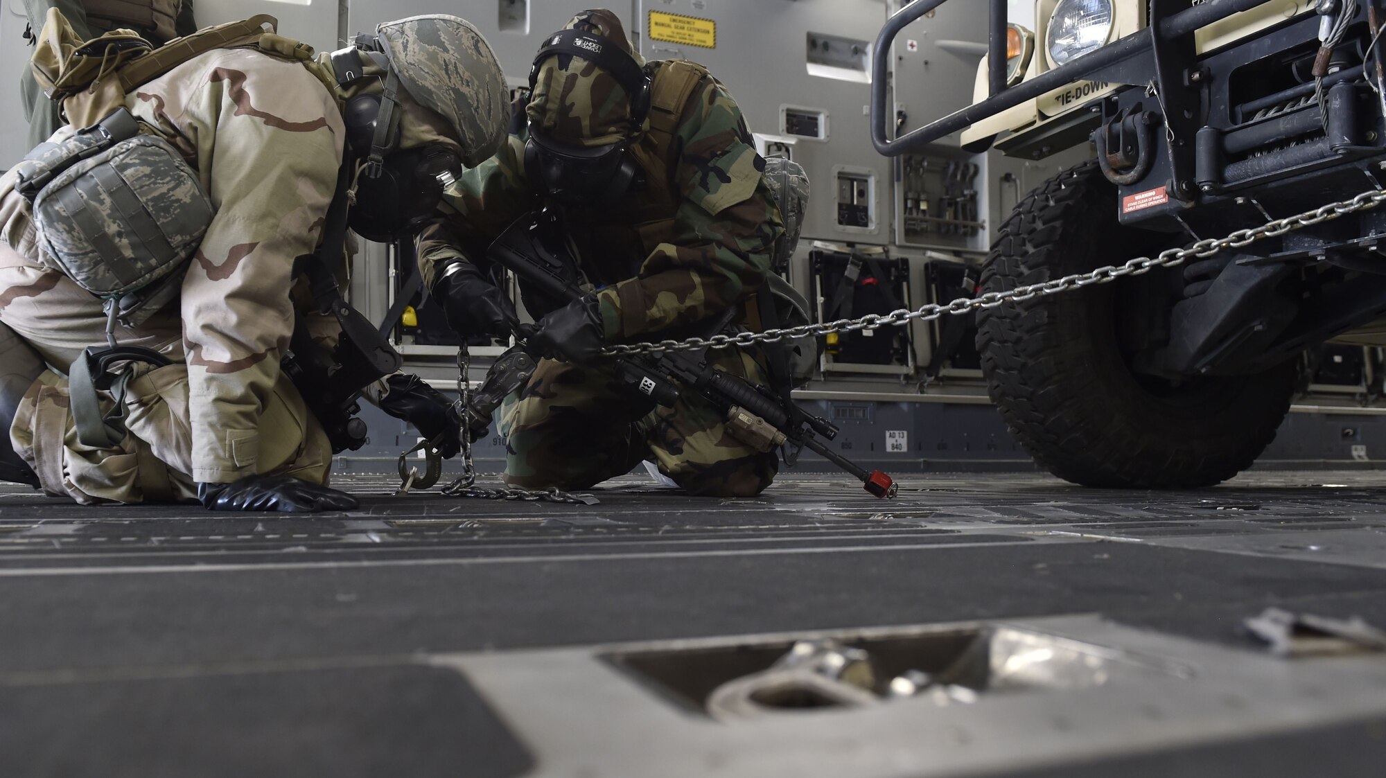 Airmen assigned to the 821st Contingency Response Group secure cargo on a C-17 Globemaster aircraft at Amedee Army Airfield, Calif., as part of a week-long readiness exercise, Feb. 1, 2018.  The exercise evaluated the Airmen’s readiness and ability to execute and sustain rapid global mobility around the world. (U.S. Air Force photo by Tech. Sgt. Liliana Moreno/Released)