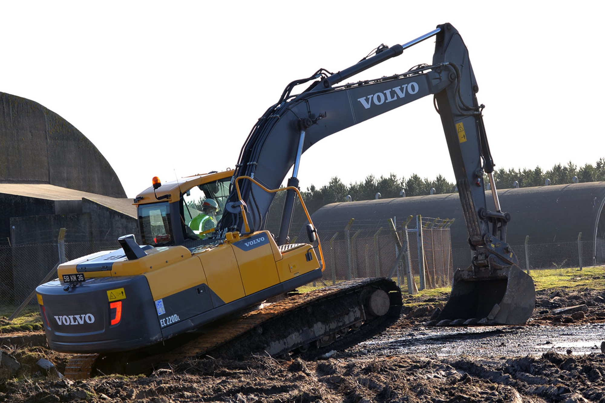 U.S. Air Force Staff Sgt. William Baynard, 100th Civil Engineer Squadron pavements and equipment supervisor, drives an excavator used by the British Army at Rock Barracks, Woodbridge, England, Jan. 25, 2018. The excavator followed the jack hammer – used to initially break up the concrete – and rip up chunks of it to be hauled away. Using the equipment gave the 100th CES Airmen valuable “stick time,” which they are not easily able to get as there are no excavators at RAF Mildenhall. (U.S. Air Force photo by Karen Abeyasekere)