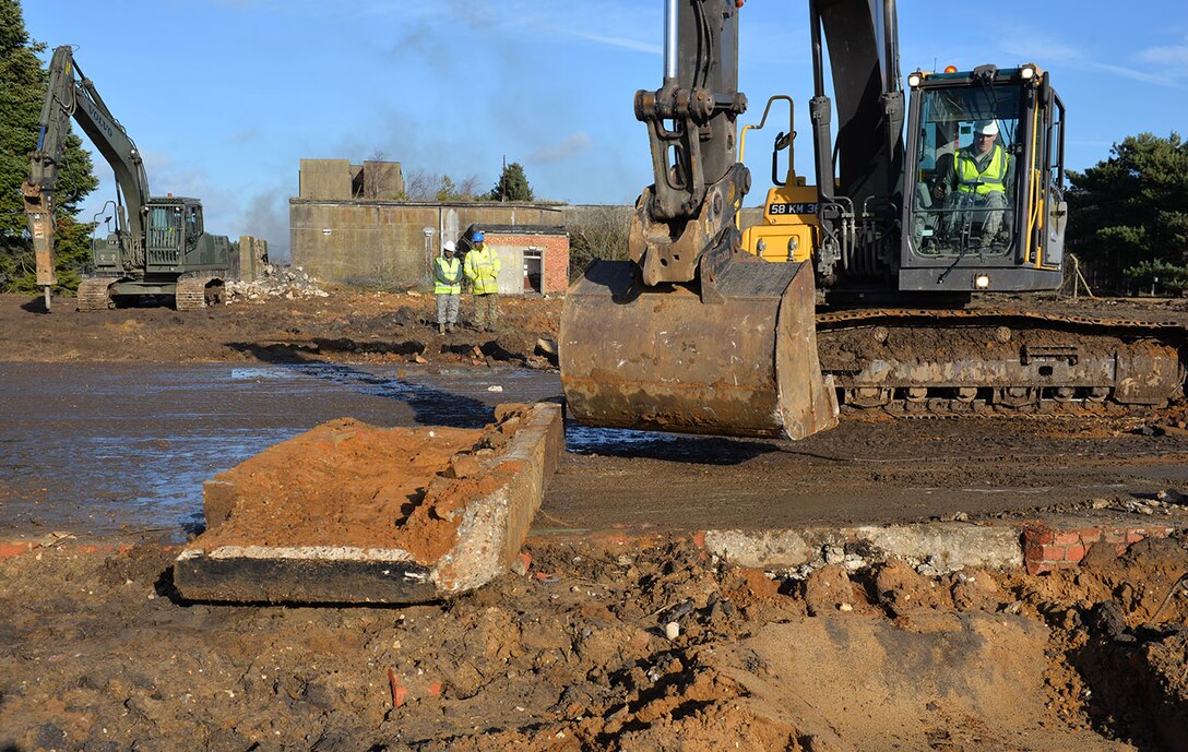 U.S. Air Force Staff Sgt. William Baynard, 100th Civil Engineer Squadron pavements and equipment supervisor, breaks up a concrete apron using a British Army excavator at Rock Barracks, Woodbridge, England, Jan. 25, 2018. The excavator followed the jack hammer – used to initially break up the concrete – and ripped up chunks of it to be hauled away. Using the equipment gave the 100th CES Airmen valuable “stick time,” which they are not easily able to get as there are no excavators at RAF Mildenhall. (U.S. Air Force photo by Karen Abeyasekere)
