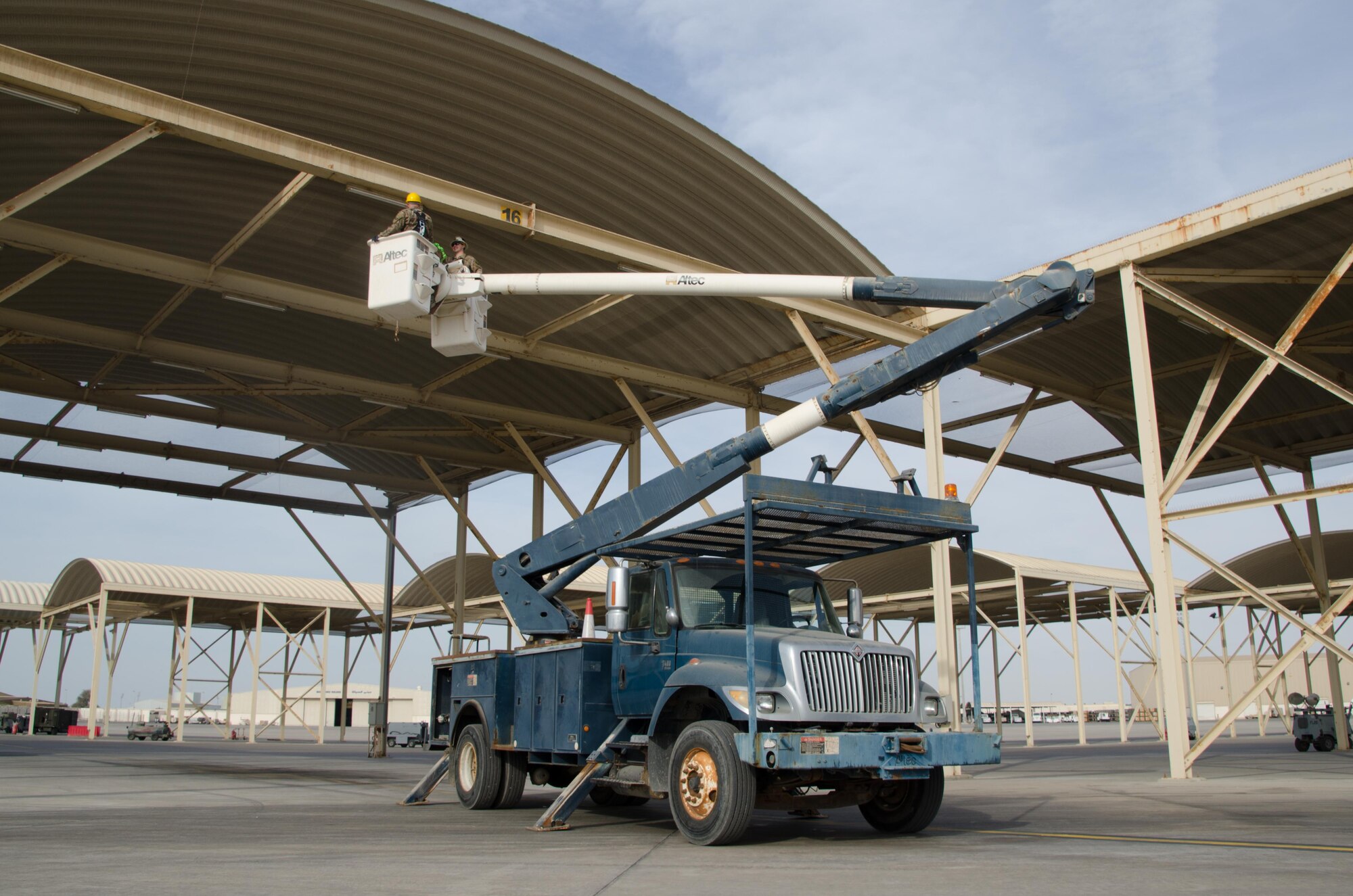 U.S. Air Force Senior Airman Robert Haehnel, 380th Expeditionary Civil Engineer Squadron electrical specialist, installs a new energy efficient light-emitting diodes (LED) light bulb on Al Dhafra Air Base, United Arab Emirates, Jan. 29, 2018. The 380th ECES electrical section has replaced more than 2,000 incandescent light bulbs on ADAB. (U.S. Air National Guard photo by Staff Sgt. Colton Elliott)