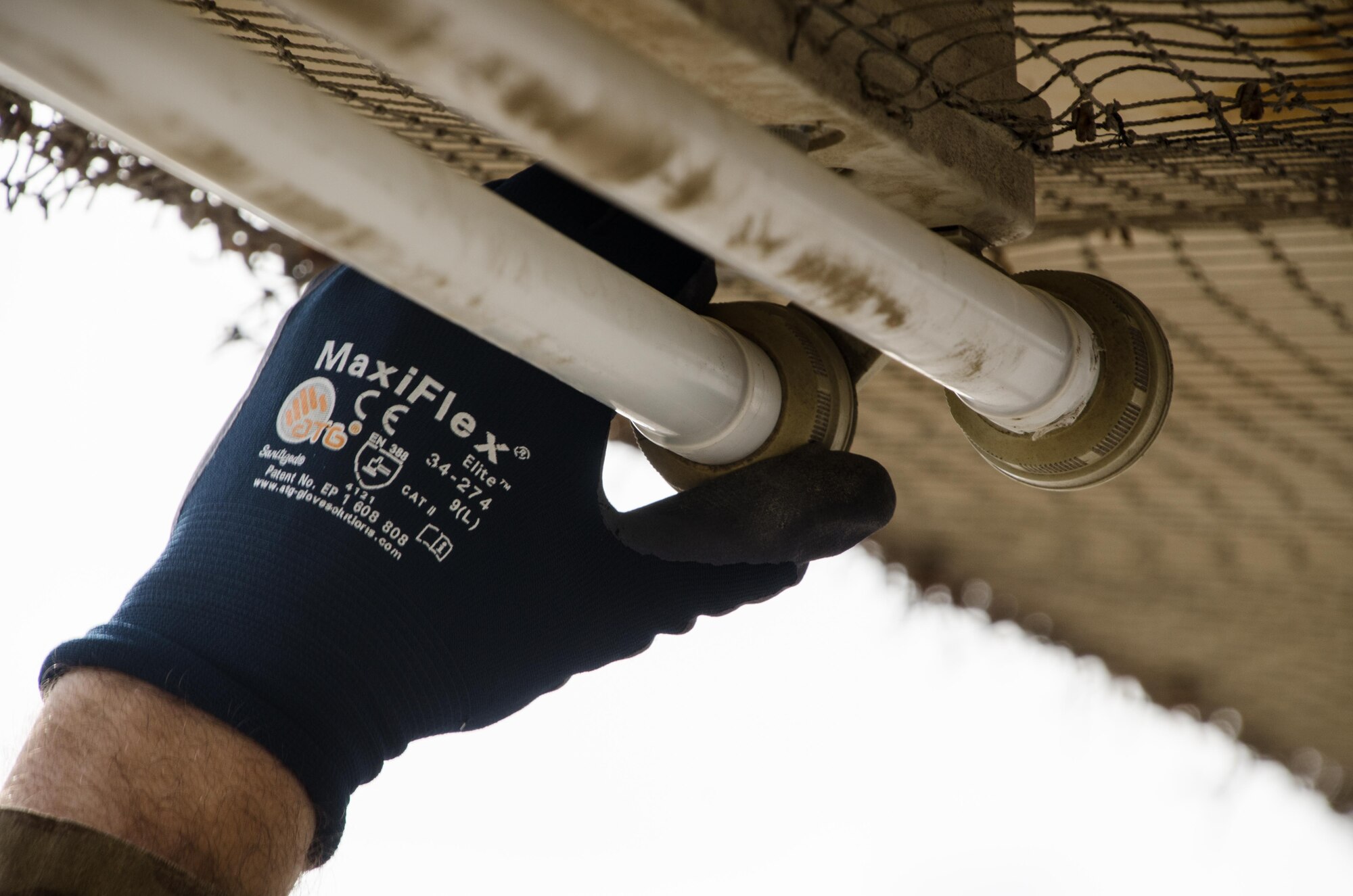 U.S. Air Force Senior Airman Robert Haehnel, 380th Expeditionary Civil Engineer Squadron electrical specialist, replaces old incandescent light bulbs with new energy efficient light-emitting diodes (LED) bulbs on Al Dhafra Air Base, United Arab Emirates, Jan. 29, 2018. The 380th ECES electrical squadron has replaced more than 2,000 incandescent light bulbs with energy efficient LEDs. (U.S. Air National Guard photo by Staff Sgt. Colton Elliott)