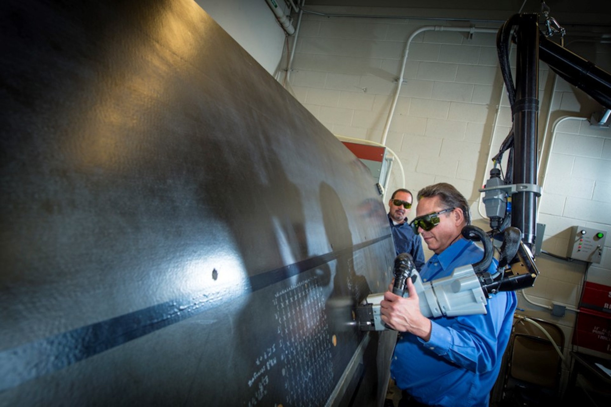 A researcher uses Laser Bond Inspection on a large structure at the Boeing Laser Bond Inspection Laboratory in Seattle, Washington. (Courtesy photo)
