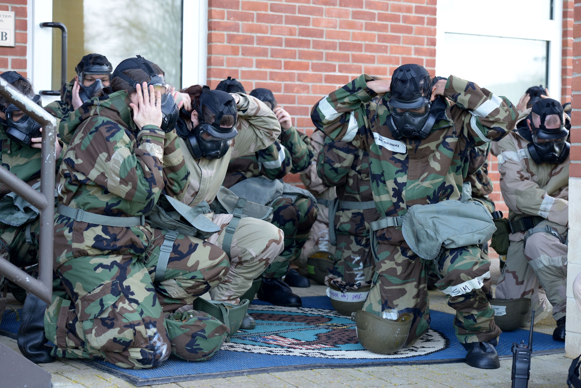 U.S. Airmen assigned to the 100th Air Refueling Wing put on their M50 gas masks during a chemical, biological, radiological and nuclear defense survival skills class at RAF Mildenhall, England, Jan. 30, 2018.  M50 gas masks are part of the protective gear worn during mission oriented protective posture (MOPP) levels three and four. (U.S. Air Force photo by Senior Airman Alexandra West)