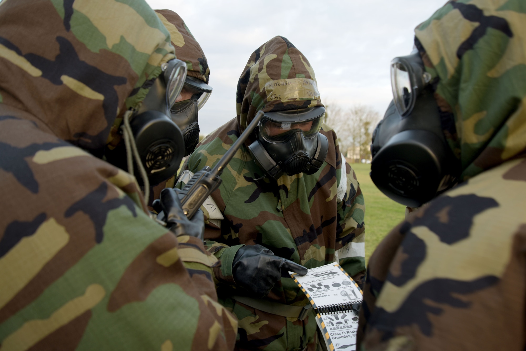 U.S. Airmen assigned to the 100th Air Refueling Wing identify the type of unexploded ordnance found during a post attack reconnaissance sweep exercise at RAF Mildenhall, England, Jan. 22, 2018.  Conducting a PAR sweep is part of the chemical, biological, radiological and nuclear defense survival skills class. (U.S. Air Force photo by Senior Airman Alexandra West)