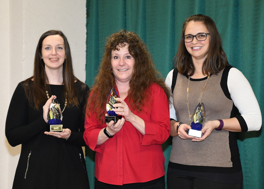 ) “Agony of Da Feet” team members (minus David Bullock): Bethany Sweatman, Jody Giacoman and Alexandra Vanaman pose with their first place trophies in the HQC Climb Mount Everest challenge. Photo by Teodora Mocanu.