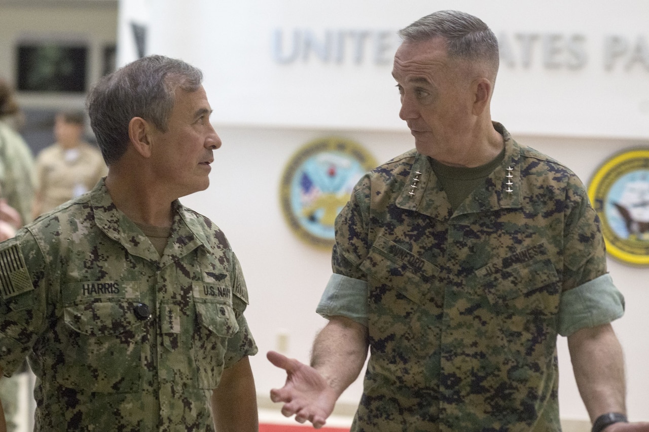 Two military leaders talk together.