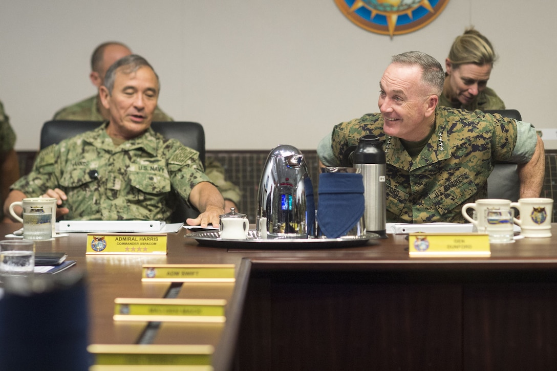 Military leaders meet at a conference table in Hawaii.