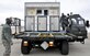 Senior Airman Michael Thompson, left, part of the air transportation crew securing an air transportable galley-lavatory on a 25K Halvorsen Loader bound for Hickam Hickam Air Force Base, Hawaii, in support of exercise Sentry Aloha