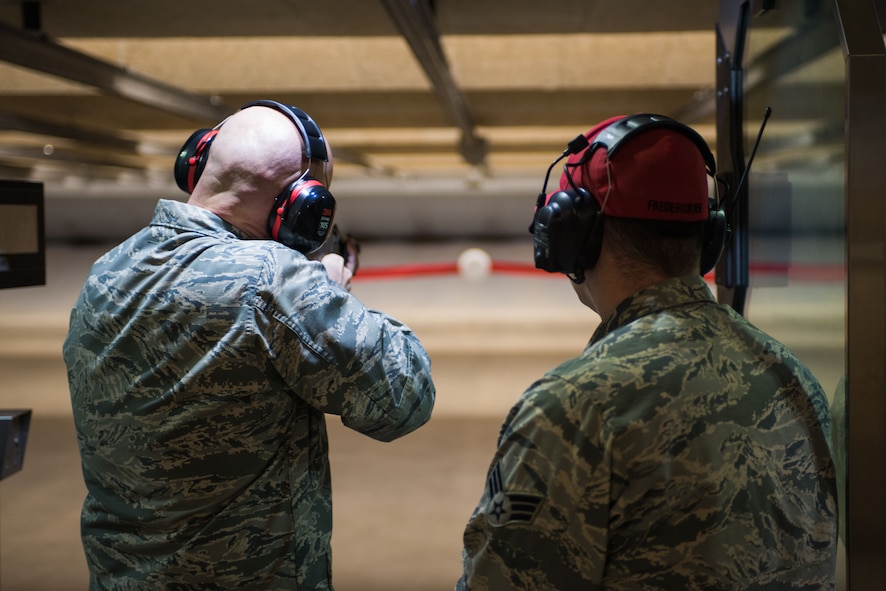 U.S. Air Force Col. Michael Manion, 55th Wing commander, prepares to fire during the ribbon shooting ceremony for the new combat arms firing range at Offutt Air Force Base, Neb. Jan. 29, 2018.