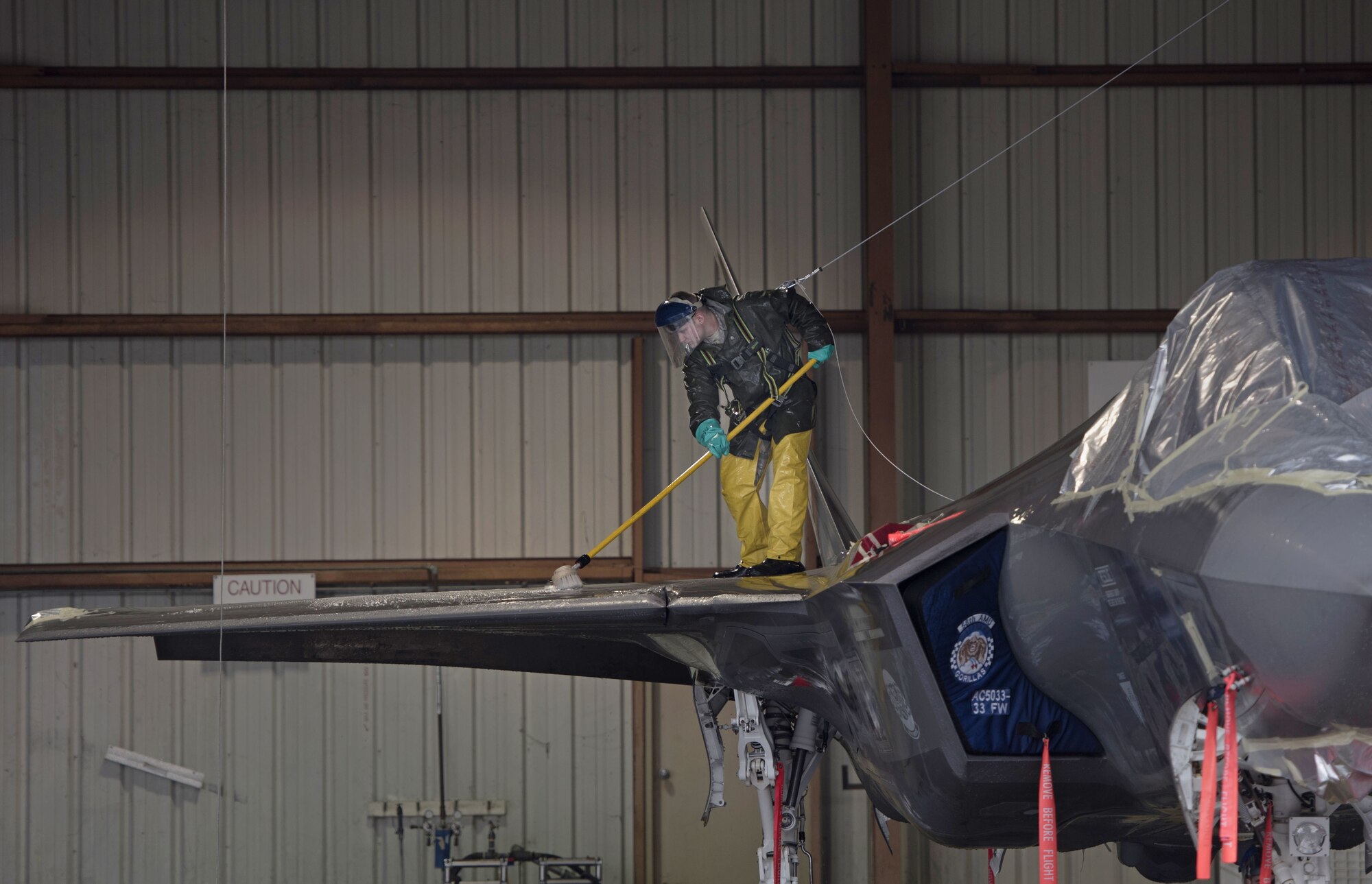 Airman 1st Class Landon Overshiner, 33rd Aircraft Maintenance Squadron crew chief, cleans the top of an F-35A Lightning II, Jan. 8, 2018, at Eglin Air Force Base, Fla. (U.S. Air Force photo by Staff Sgt. Peter Thompson)