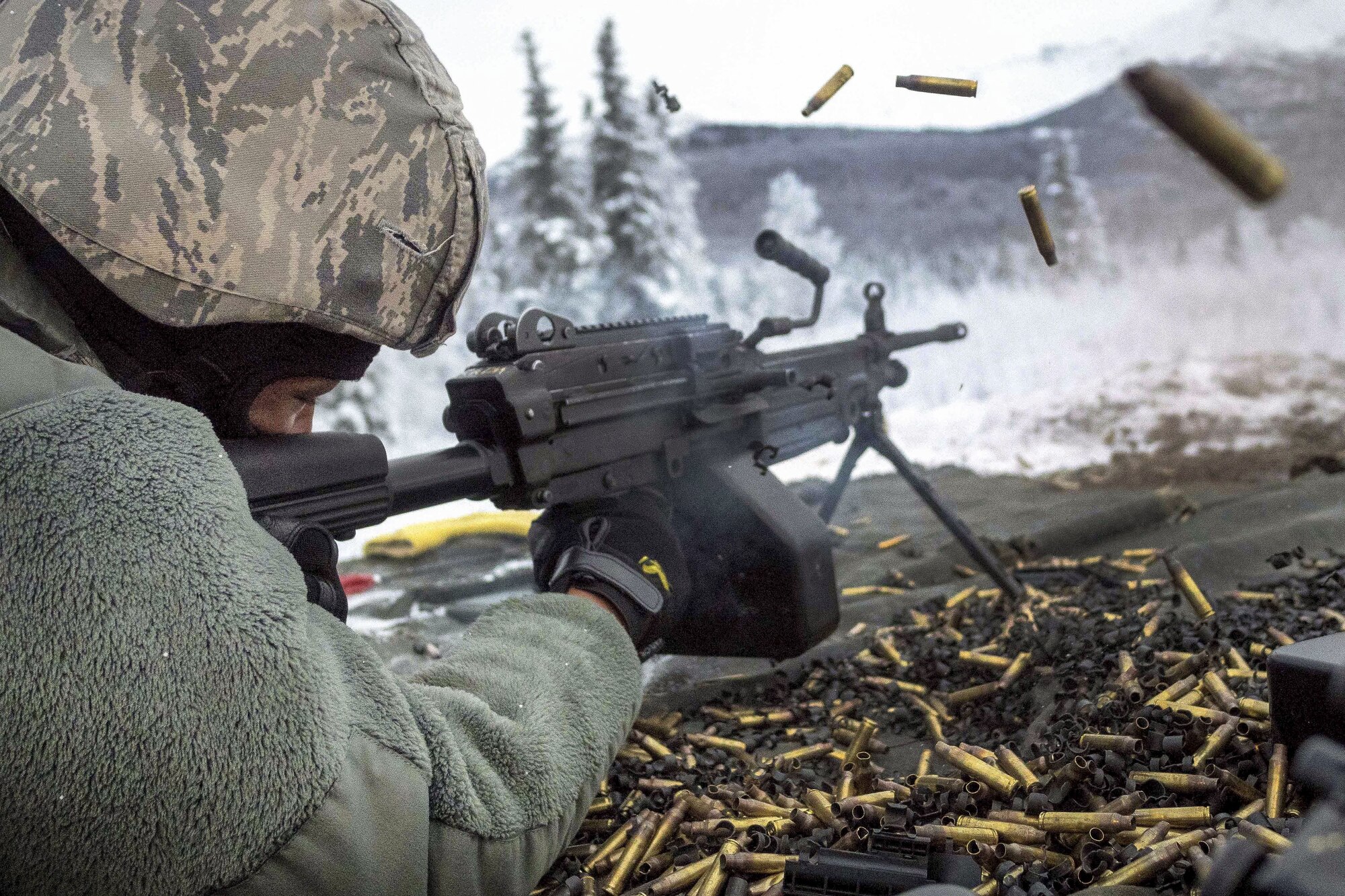 Airman 1st Class Kaylon Thomas fires at a target with an M249 squad automatic weapon during a machine gun qualification at Joint Base Elmendorf-Richardson, Alaska, Jan. 10, 2018. Thomas is a security forces officer assigned to the 673rd Security Forces Squadron. (U.S. Air Force photo by Justin Connaher)