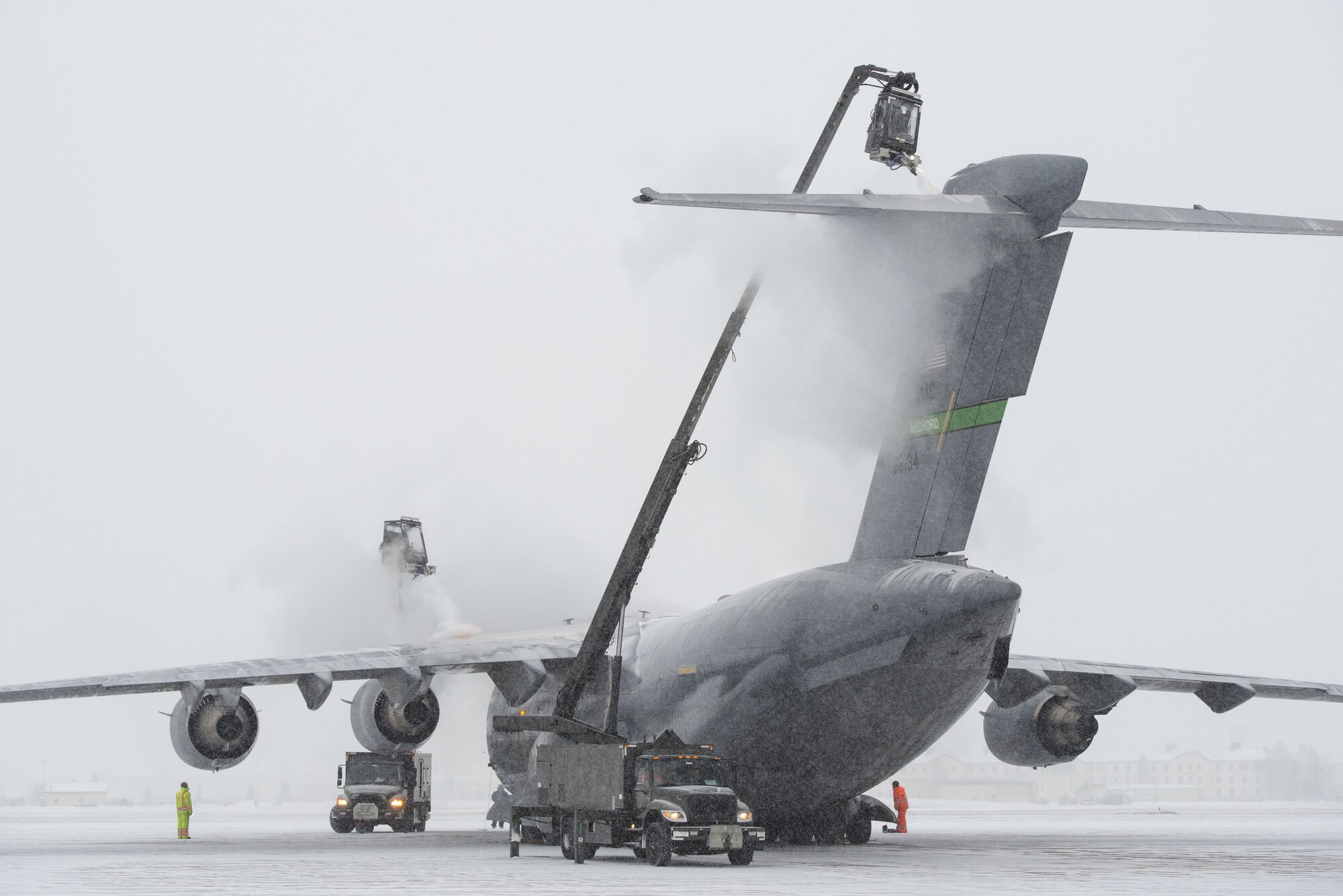 Airmen assigned to the 732nd Air Mobility Squadron de-ice a C-17 Globemaster III out of Joint Base Lewis-McChord, Wa., while conducting flight operations at Joint Base Elmendorf-Richardson, Alaska, Jan. 25, 2018. During the harsh Alaskan winters de-icing keeps aircraft operational by removing layers of snow, ice and frost that could adversely affect flights. (U.S. Air Force photo by Alejandro Peña)