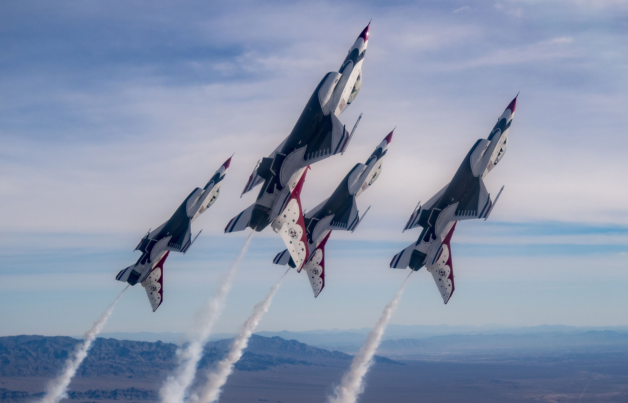 The Thunderbirds Diamond formation pilots transition during a Line Break Loop maneuver over the Nevada Test and Training Range during a training flight, Jan. 29, 2018. The Diamond formation exhibits the precision and skill to fly in close formation. (U.S. Air Force photo by Tech. Sgt. Christopher Boitz)