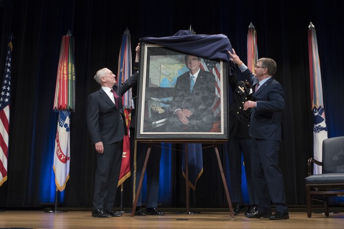 Two defense leaders unveil a portrait during a ceremony at the Pentagon.