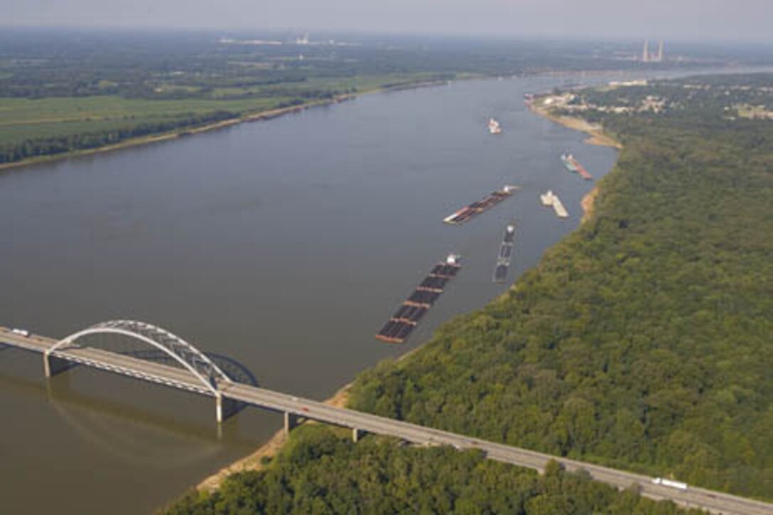 A picture of a barge proceeding to Locks and Dam 52/53