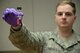 Senior Airman William Raetz, 341st Medical Operations Squadron bioenvironmental engineering technician, holds a vial of a water sample with a chlorine reagent Jan. 31, 2018, at Malmstrom Air Force Base, Mont.