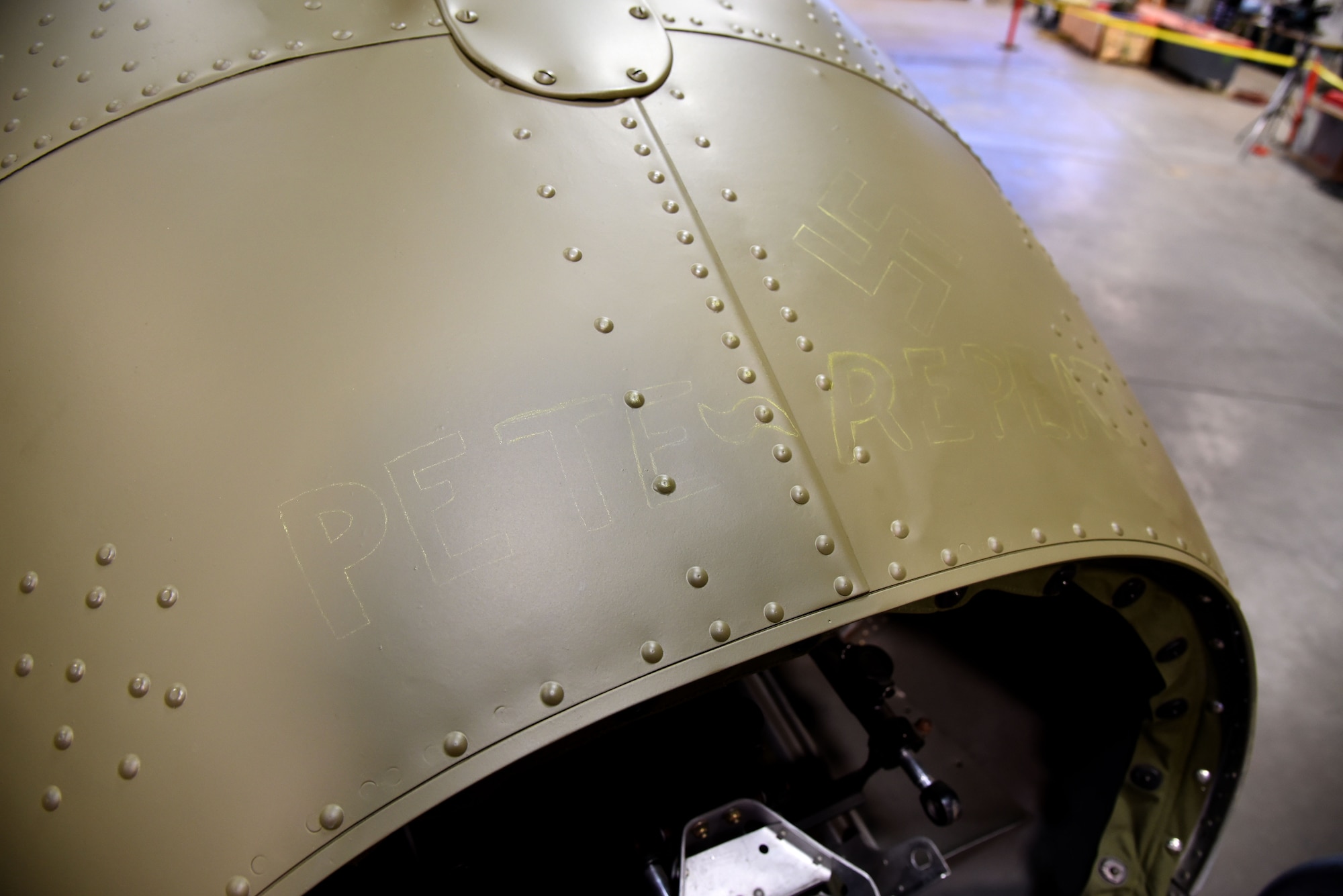 (02/01/2018) A view of the Boeing B-17F Memphis Belle tail gun position in the museum's restoration hangar. SSgt. John Quinlan the tail gunner of the Memphis Belle crew named the guns Pete and Repeat during WWII. Museum restoration specialist Casey Simmons repainted the names on the tail. (U.S. Air Force photo by Ken LaRock)