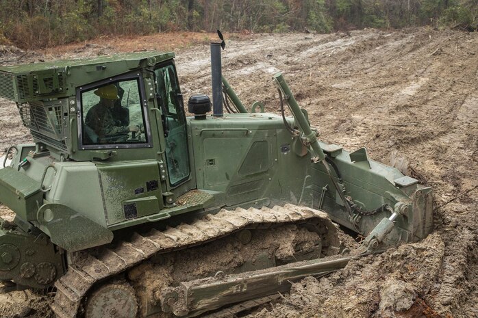 Lance Cpl. Devin Nafzinger, a heavy equipment operator with 8th Engineer Support Battalion, 2nd Marine Logistics Group, uses a Medium Crawler Tractor to clear a section of land aboard Camp Lejeune, N.C., Jan. 29, 2018. The land was cleared to make room to facilitate more advanced future structures being constructed. (U.S. Marine Corps photo by Lance Cpl. Tyler W. Stewart)