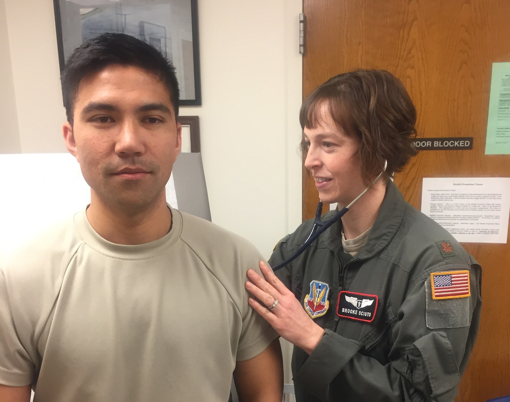 Maj. Brooke Sciuto, 55th Medical Group, Chief of Aerospace Medicine, examines a patient at Offutt Air Force Base, Neb., in January 2018.  Sciuto provides clinical care  to Airmen on flying status and serves as an advisor on all operational medicine matters relating to the wing’s mission. (Courtesy photo)