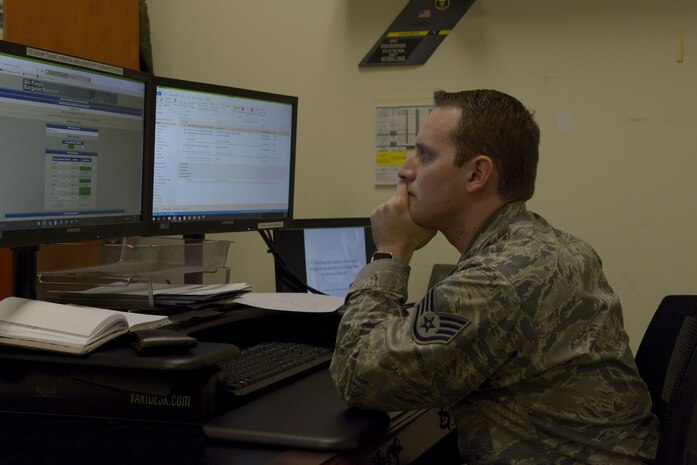 U.S. Air Force Staff Sgt. Brian Spears, 437th Operations Support Squadron aircrew flight equipment lead trainer, reviews training requirements for members of his squadron Feb. 1, 2018.