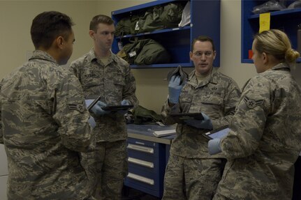 U.S. Air Force Staff Sgt. Brian Spears, 437th Operations Support Squadron aircrew flight equipment lead trainer, center, quizzes Airmen on the proper procedures for maintaining an oxygen mask during a training session Feb. 1, 2018.