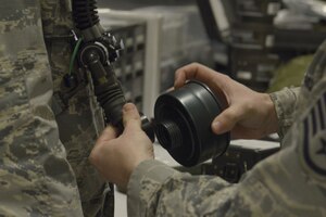 U.S. Air Force Staff Sgt. Brian Spears, 437th OSS aircrew flight equipment lead trainer, demonstrates the proper procedure for attaching a filter cartridge to an oxygen tube during a training session Feb. 1, 2018.