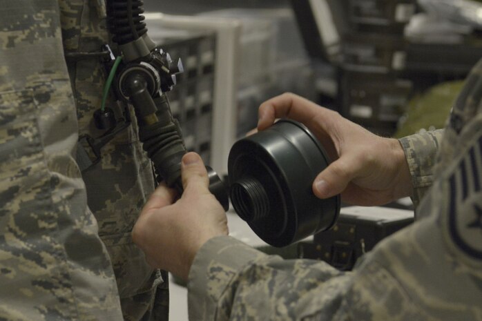 U.S. Air Force Staff Sgt. Brian Spears, 437th OSS aircrew flight equipment lead trainer, demonstrates the proper procedure for attaching a filter cartridge to an oxygen tube during a training session Feb. 1, 2018.
