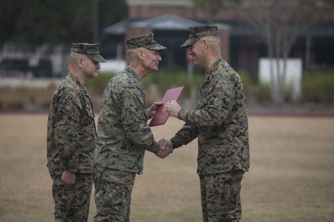 Lt. Gen. Rex C. McMillian, center, commander of Marine Forces Reserve and Marine Forces North, relinquished Sgt. Maj. Patrick J. Kimble, right, of his duties as force sergeant major of MARFORRES and MARFORNORTH, during the relief and appointment ceremony held at Marine Corps Support Facility, New Orleans, Louisiana, Feb. 2, 2018. Kimble served as the force sergeant major from 2016-2018 and has relinquished his duties to Sgt. Maj. Scott D. Grade. (U.S. Marine Corps Photograph by Lance Cpl. Ricardo Davila/Released)