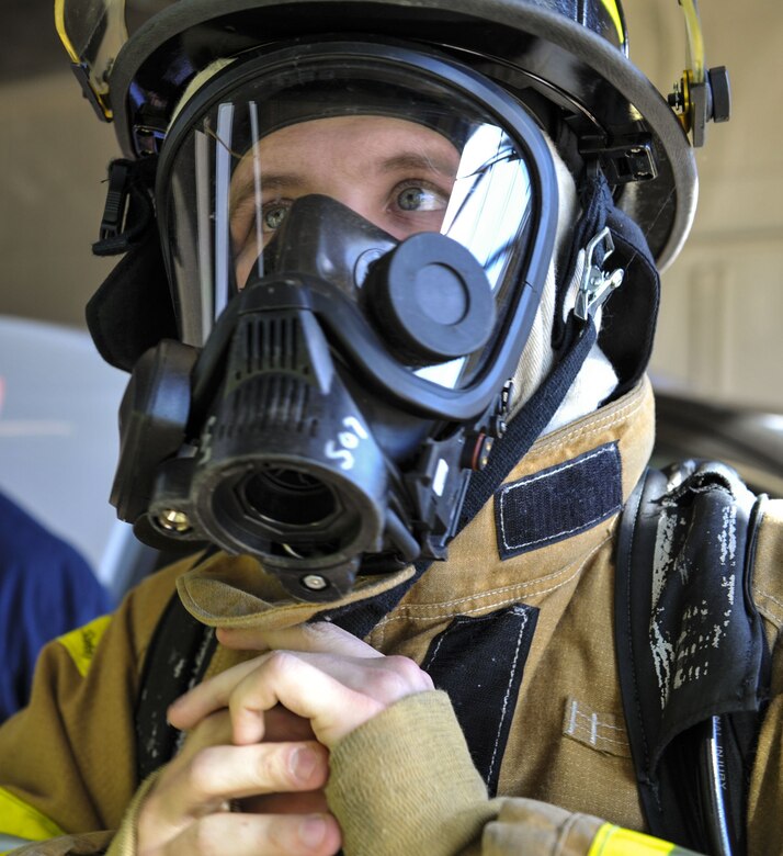 Airman 1st Class Michael Lawhorn, 628th Civil Engineer Squadron firefighter dons his fire protection gear Jan. 26, 2018, at Joint Base Charleston – Weapons Station, S.C.