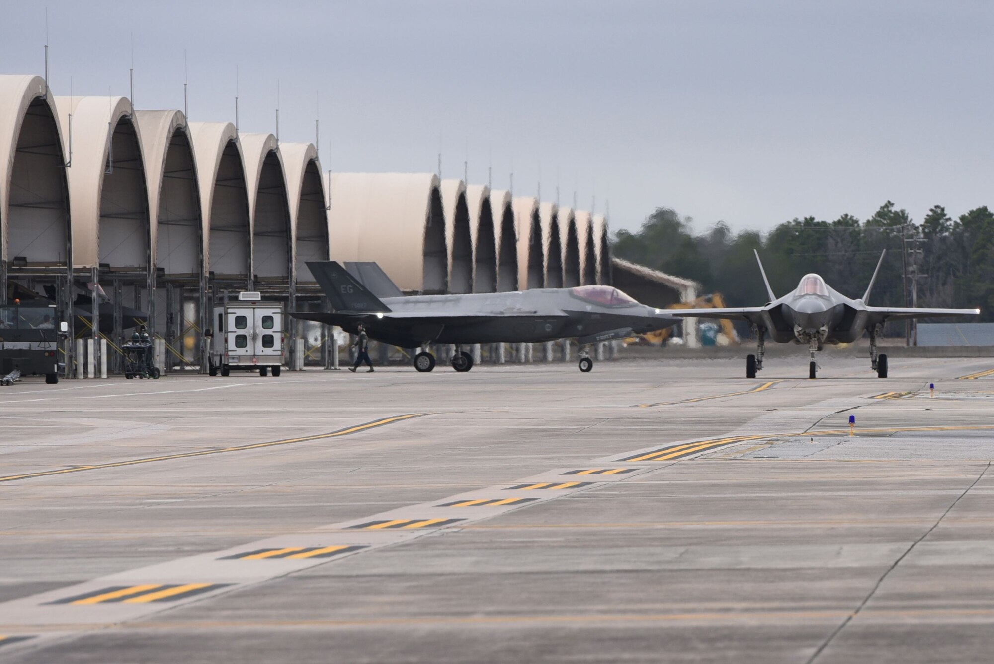 Two F-35As Lightning II taxi prior to taking off for an expanded Lightning Top Off Course Jan. 29, 2018, at Eglin Air Force Base, Fla. The two week expanded LiTOC included combat aircraft from the U.S. Navy and Air Force in a large force exercise aimed at providing F-35A pilots with experience before entering the Combat Air Force. During the expanded LiTOC, pilots receive half of the flights required to complete mission qualification training, drastically reducing their training timeline. (U.S. Air Force photo by Airman 1st Class Emily Smallwood/Released)