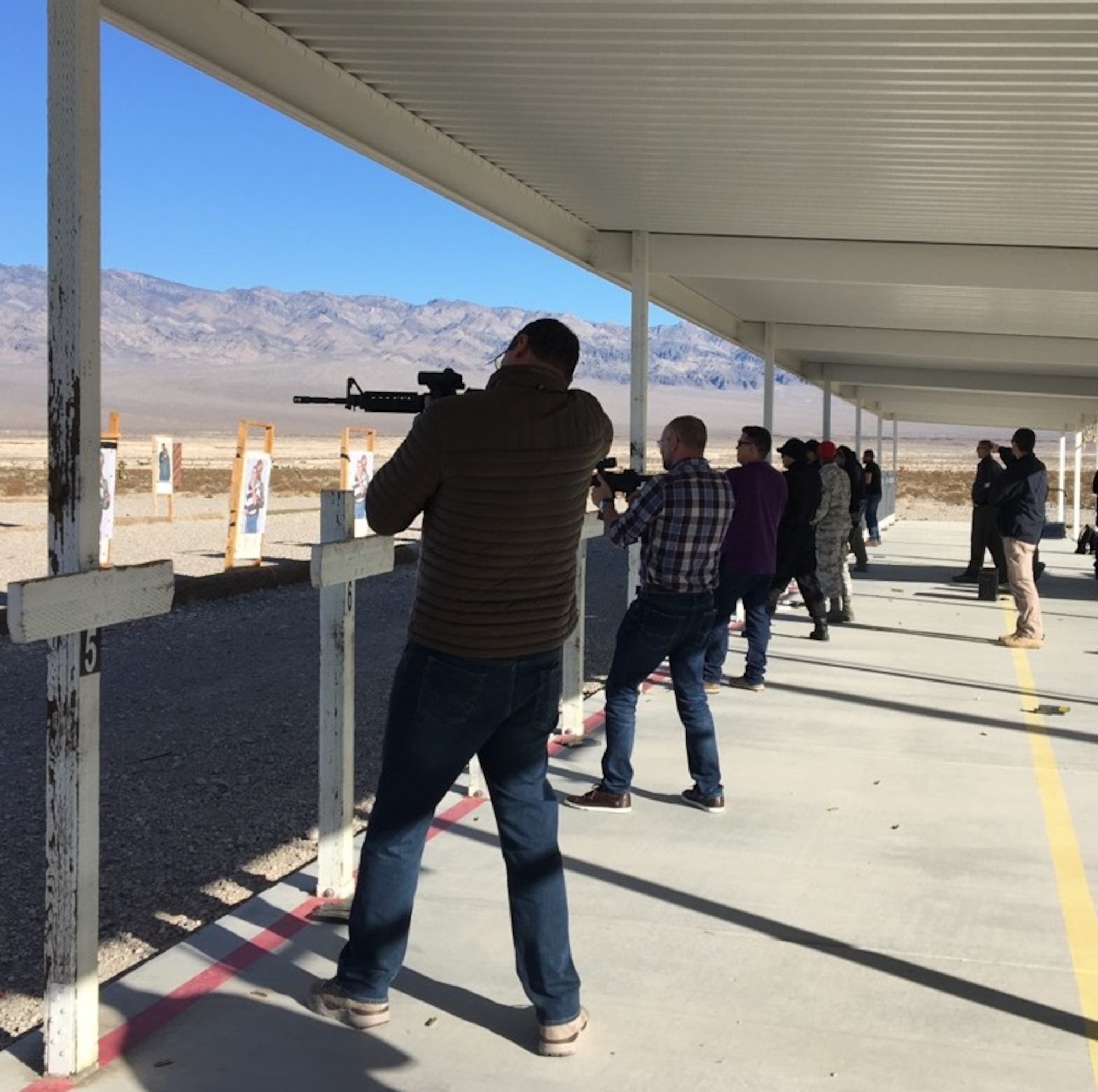 Shooters line up targets at the Creech AFB, Nev., Range in January 2018. The shooters included 11 Brazilian Law Enforcement Officials visiting Las Vegas to attend the annual Shooting, Hunting and Outdoor trade Show as part of an AFOSI liaison event. (Photo submitted by AFOSI Det. 202)